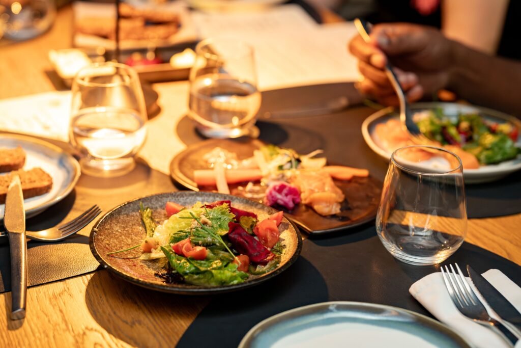 The Hidden Link Between Soil Health and Human Nutrition A beautifully set dinner table with gourmet salads and glassware, ideal for a classy dining experience.